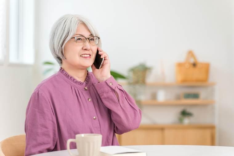 スマートフォンで通話する高齢の女性